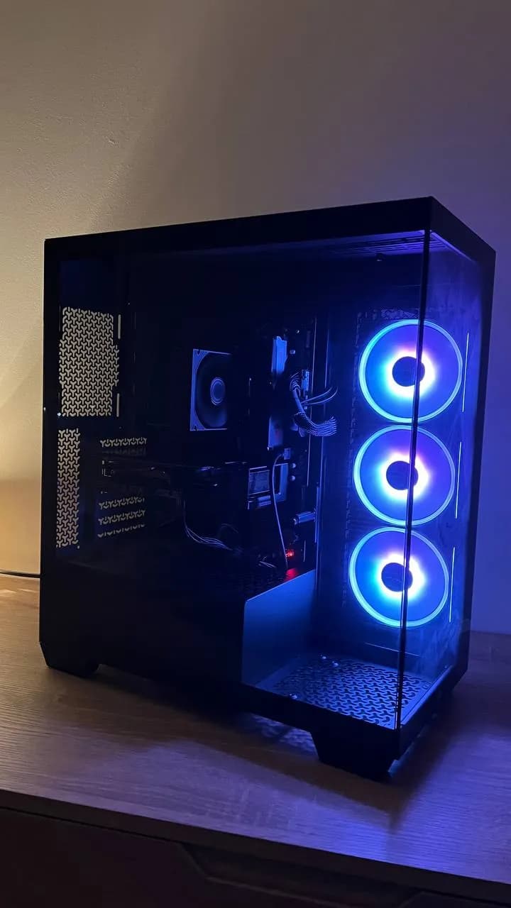 A ForgePC custom gaming PC with blue lighting on the workshop bench